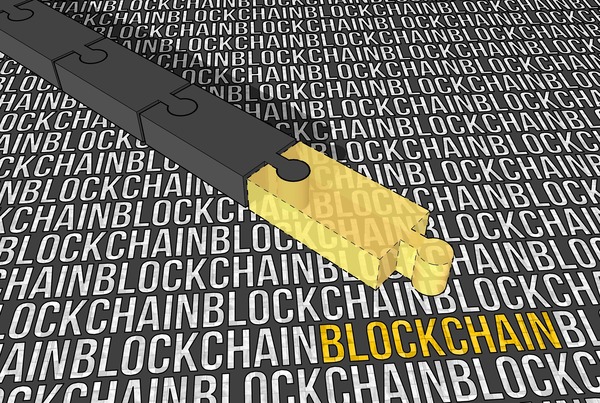 Puzzle pieces on a surface covered with the word blockchain