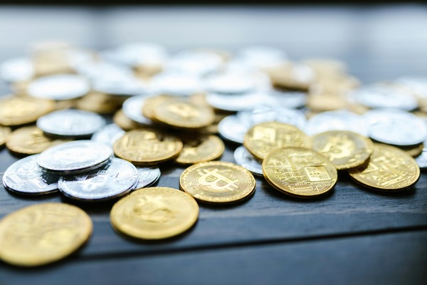 Gold and silver cryptocurrency coins scattered on a table