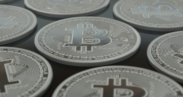 Silver cryptocurrency coins laid out in rows