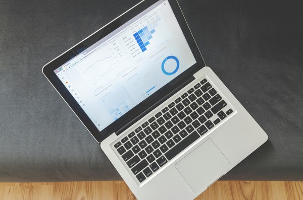 Open laptop with analytics charts seen from above